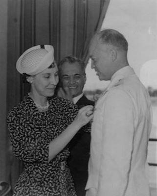 Mamie pins the Philippine Distinguished Service Star conferred by President Quezon on Ike.
