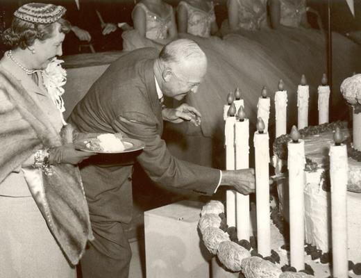 MAMIE LOOKS ON AS EISENHOWER CUTS HIS BIRTHDAY CAKE, HERSHEY, PA, 1953